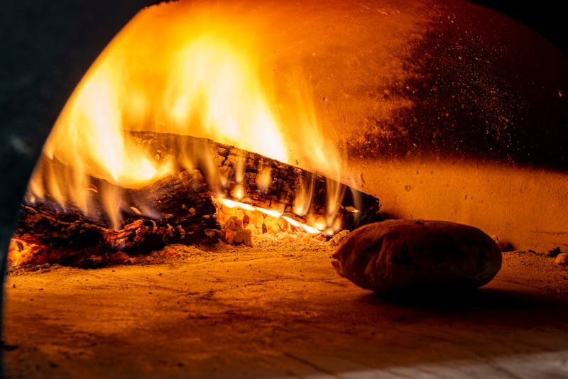 Fresh pizza ingredients being prepared by kitchen staff